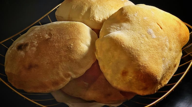 Zakia's pitas, which are cooked in a special oven in about 70 seconds, are light and puffy. Henri Hollis/henri.hollis@ajc.com