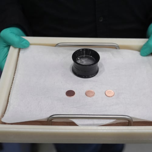 FILE - Blank coins wait to be the last pennies pressed at the U.S. Mint, in Philadelphia, Nov. 12, 2025. (AP Photo/Matt Slocum, File)