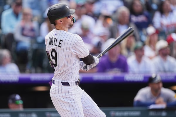 Colorado Rockies' Brenton Doyle follows the flight of his solo home run off Atlanta Braves starting pitcher Chris Sale in the third inning of a baseball game Wednesday, April 30, 2025, in Denver. (AP Photo/David Zalubowski)