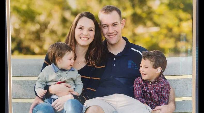 Devon and Jill Phelps pose with their sons, ages 2 and 4. The couple was struck by a vehicle while jogging along the Chattahoochee River in Roswell. (Courtesy of the Phelps family)