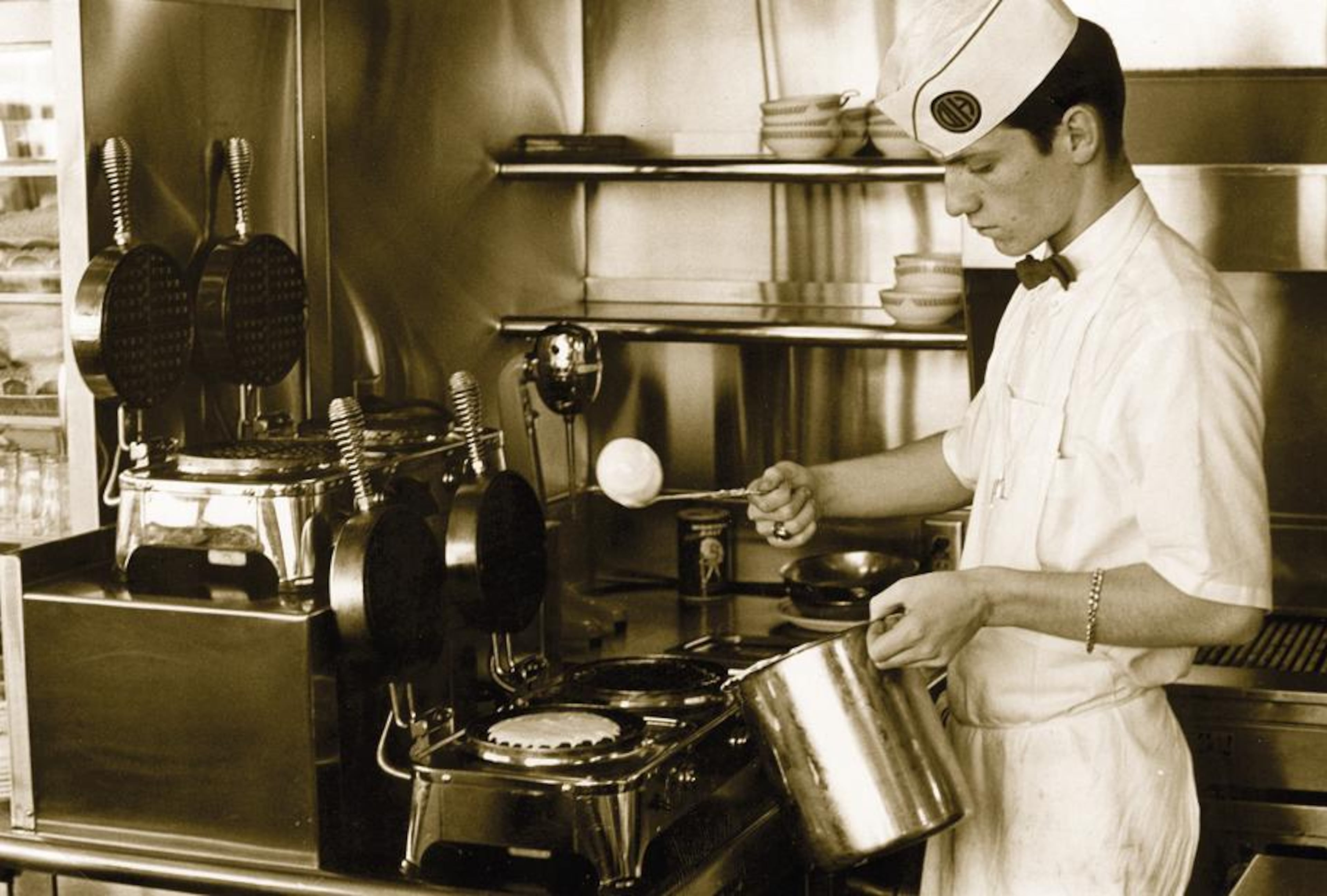 1960s: A Waffle House cook makes waffles.