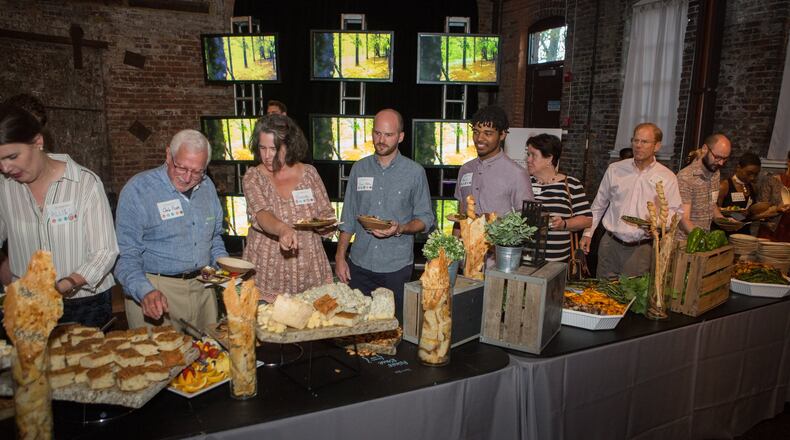 A documentary played on a video board as guests enjoyed the prepared foods from local farms during the Food Well Alliance’s annual Love Local event at the King Plow Arts Center on Oct. 5. CONTRIBUTED BY PHIL SKINNER