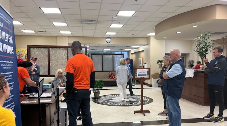 State Sen. Brandon Beach, R-Alpharetta, (second from right) watches as absentee ballots are tallied in the North Fulton service Center in Sandy Springs. A Fulton County judge Saturday, responding to a GOP lawsuit, ruled the practice was allowed by state law, but several activists have complained it is an irregular continuation of early voting, which ended Friday. (Ashley Ahn/AJC)