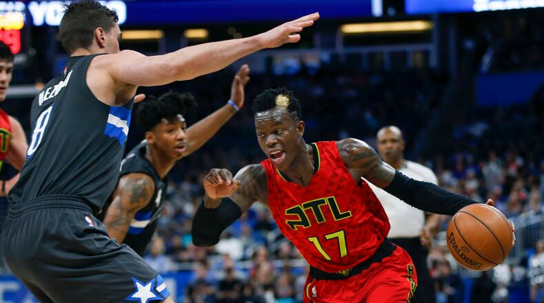 Atlanta Hawks guard Dennis Schroder (17) drives the ball around Orlando Magic guard Mario Hezonja (8) during the second half of an NBA basketball game in Orlando, Fla., on Saturday, Feb. 25, 2017.The Magic won 105-86. (AP Photo/Reinhold Matay)