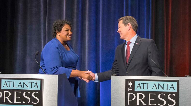 Democratic nominee for governor Stacey Abrams and Republican nominee Brian Kemp greet each other before a live taping of a debate. The candidates each reported Thursday raising more than $20 million over the course of the campaign. (ALYSSA POINTER/ALYSSA.POINTER@AJC.COM)