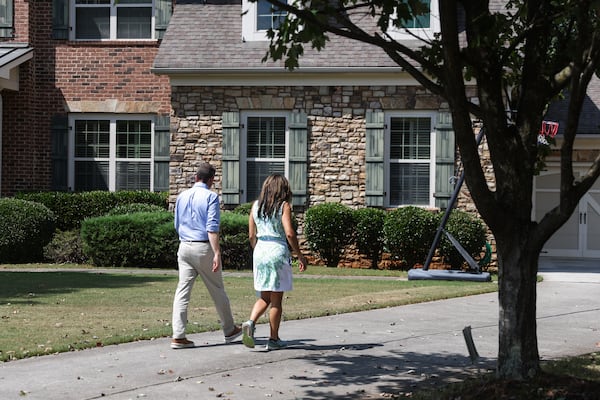 DNC Chair Ken Martin and Senate District 21 Candidate Debra Shigley walk to a house to campaign in Milton, Ga, on Saturday, September 20, 2025. (Abbey Cutrer / AJC)