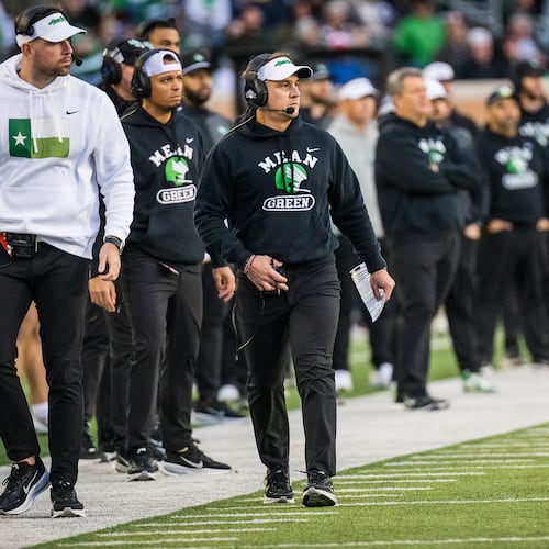 North Texas head coach Eric Morris, front right, walks the sideline during an NCAA college football game against Temple, Friday, Nov. 28, 2025, Denton, Texas. (AP Photo/Jessica Tobias)