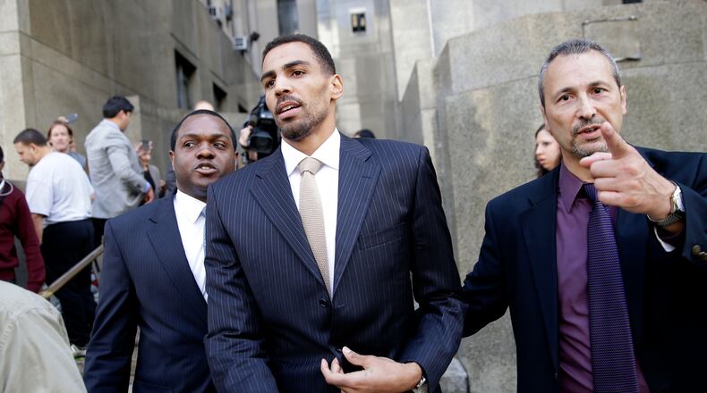Thabo Sefolosha, center, leaves criminal court in New York, Friday. The Atlanta Hawks' player was acquitted in a case stemming from a police fracas outside a trendy New York City nightclub last April. (AP photo)