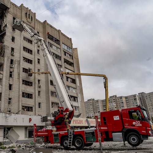 Firefighters put out a fire after a residential building was hit following Russia's drone attack in Kharkiv, Ukraine, Sunday, Aug. 9, 2026. (AP Photo/Andrii Marienko)