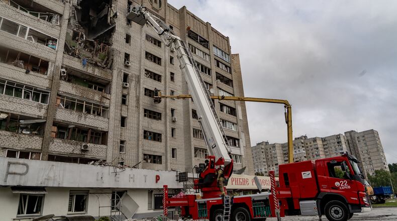 Firefighters put out a fire after a residential building was hit following Russia's drone attack in Kharkiv, Ukraine, Sunday, Aug. 9, 2026. (AP Photo/Andrii Marienko)