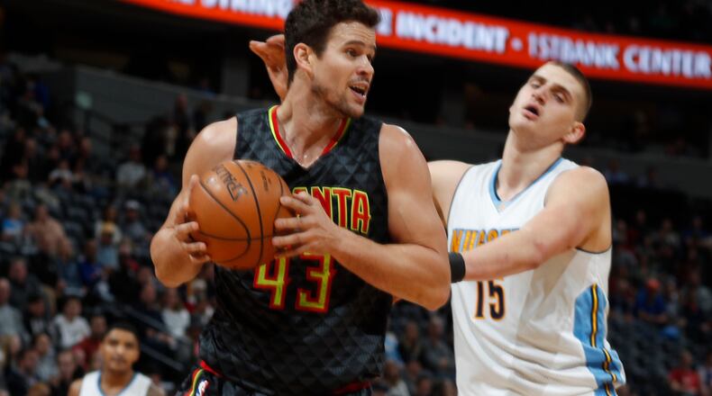 Atlanta Hawks forward Kris Humphries, left, pulls in a rebound in front of Denver Nuggets forward Nikola Jokic, of Serbia, in the first half of an NBA basketball game Friday, Dec. 23, 2016, in Denver. (AP Photo/David Zalubowski)