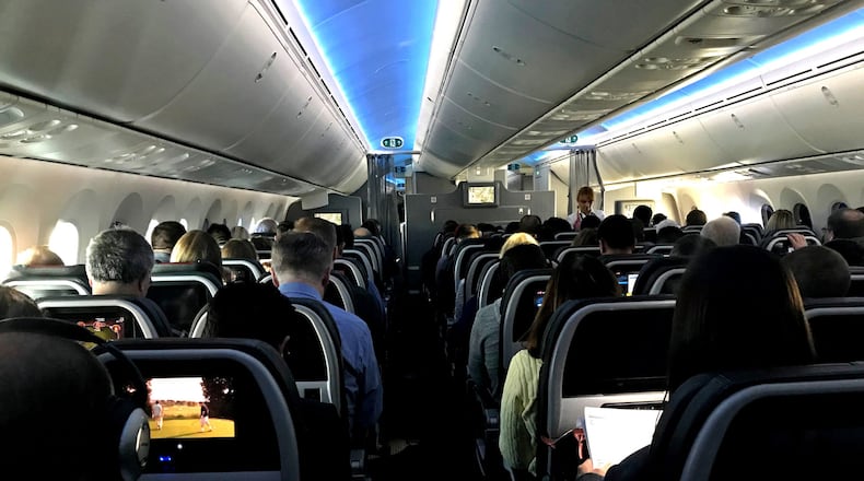 Main cabin passengers pass the time aboard American Airlines flight 2331, a Boeing 787-800 Dreamliner, an route from Chicago O’Hare International Airport to Dallas/Fort Worth International Airport, on March 5, 2018. (Jerome Adamstein/Los Angeles Times/TNS)