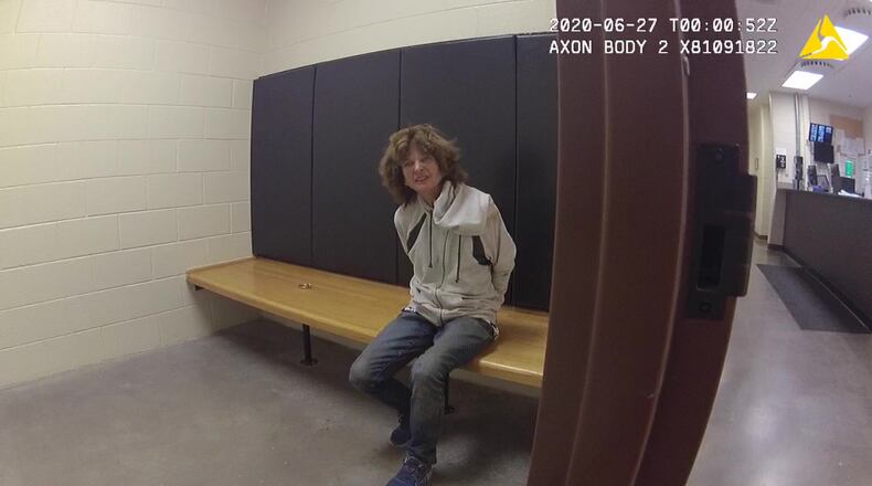 In an image provided by the Loveland Police Department, via The Life & Liberty Law Office, Karen Garner asks for help from her injuries after her arrest, on June 27, 2020. Two former police officers in Colorado are facing criminal charges in connection with the arrest last year of the 73-year-old Garner, who suffers from dementia, during which she was thrown to the ground, prosecutors announced on Wednesday, May 19, 2021.