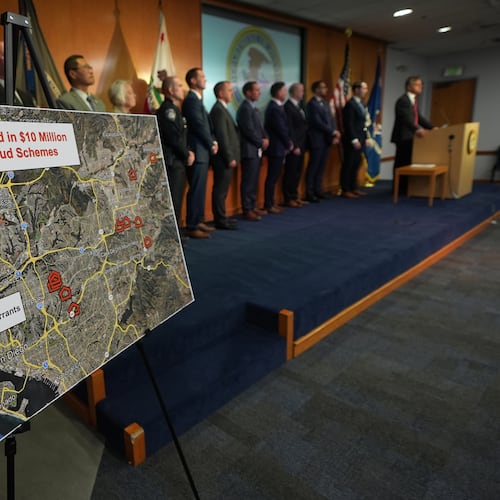 U.S. Attorney Adam Gordon announces charges against a dozen individuals for fraudulently collecting childcare payments during a press event, Tuesday, Sept. 15, 2026, in San Diego. (AP Photo/Gregory Bull)
