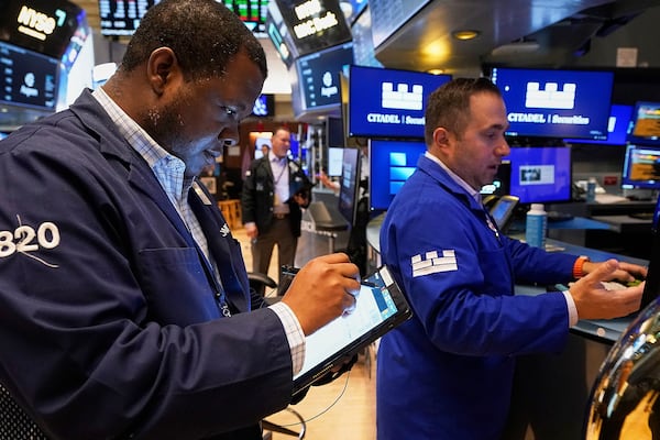 Trader Thomas Lee, left, and specialist Genarro Saporito work on the floor of the New York Stock Exchange, Thursday, May 8, 2025. (AP Photo/Richard Drew)