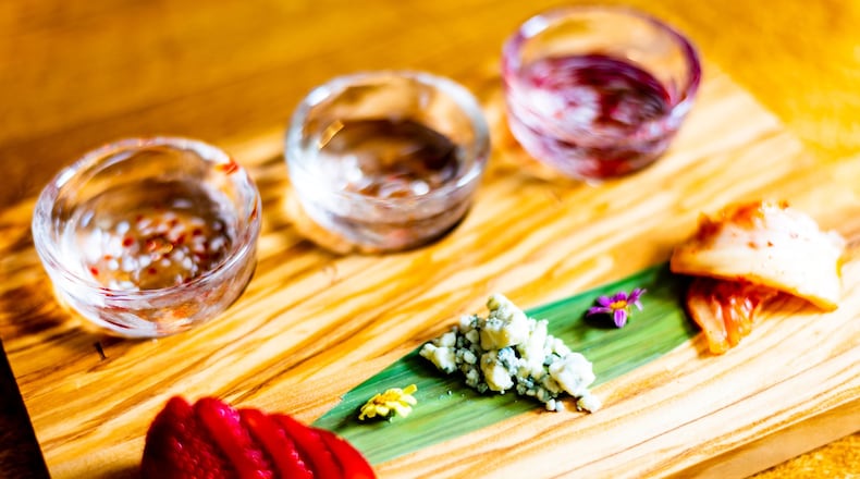 The sake flight pairing No. 1 at Chirori has three 1 1/2-ounce pours and three sweet and savory nibbles. CONTRIBUTED BY HENRI HOLLIS