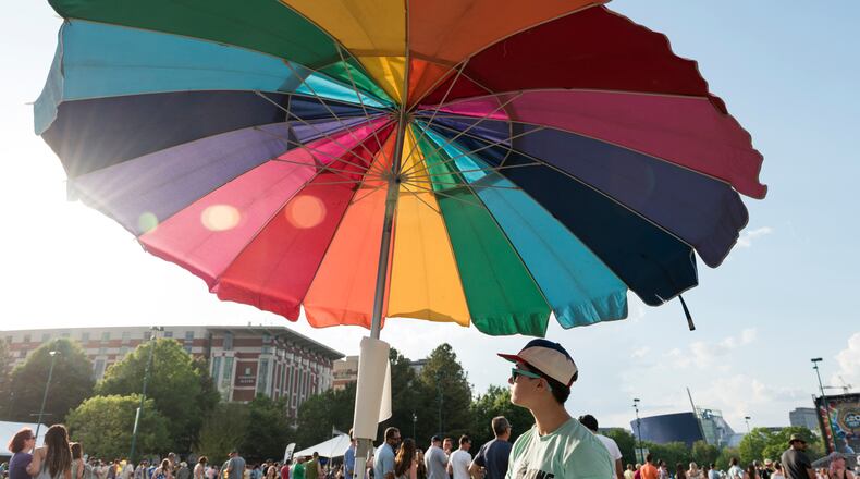 April 21, 2017, Atlanta - The wind blows the King of Pops umbrella while Alison Ortega, bottom right, from Atlanta, Georgia, mans the stand at the SweetWater 420 Fest at Centennial Olympic Park in Atlanta, Georgia, on Friday, April 21, 2017.