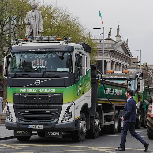 A man crosses a road where vehicles are parked on O'Connell Street, on the second day of a national fuel protest against rising fuel prices, in Dublin, Ireland, Wednesday April 8, 2026. (Brian Lawless/PA via AP)
