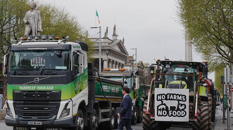A man crosses a road where vehicles are parked on O'Connell Street, on the second day of a national fuel protest against rising fuel prices, in Dublin, Ireland, Wednesday April 8, 2026. (Brian Lawless/PA via AP)