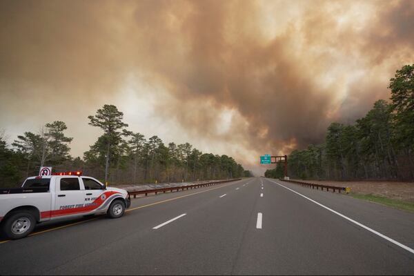 Smoke fills the sky as firefighters battle a wildfire in Lacey Townships, N.J. on Tuesday, April 22, 2025. (New Jersey Department of Environmental Protection via AP)