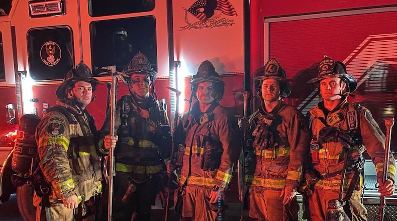 Cobb County fire crews rescued a resident from a house fire in Powder Springs on Tuesday night. Pictured (from left to right) are firefighters Gregory Futch, Adam Jones, Michael Barnett, Jimmy Gregory and Russell Andrews. (Credit: Cobb County Fire and Emergency Services)