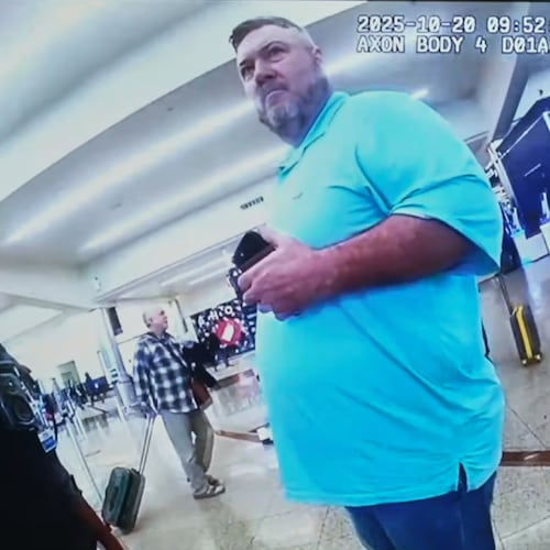 This image made from an Oct. 20, 2025, police body camera footage shows Billy Joe Cagle, of Cartersville, Ga., right, talks to police officers before he was arrested inside the domestic terminal at Hartsfield-Jackson Atlanta International Airport in Atlanta. (Atlanta Police Department via AP)