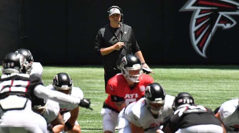 Falcons coach Arthur Smith (background) watches during the Falcons' practice at Mercedes-Benz Stadium on Saturday, August 7, 2021. (Hyosub Shin / Hyosub.Shin@ajc.com)