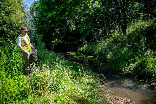 Environmental Engineer Nathan Bruce looks over the headwaters of the Flint River located on MARTA property near the College Park station Monday, May 17, 2021.  (Steve Schaefer for the AJC) 