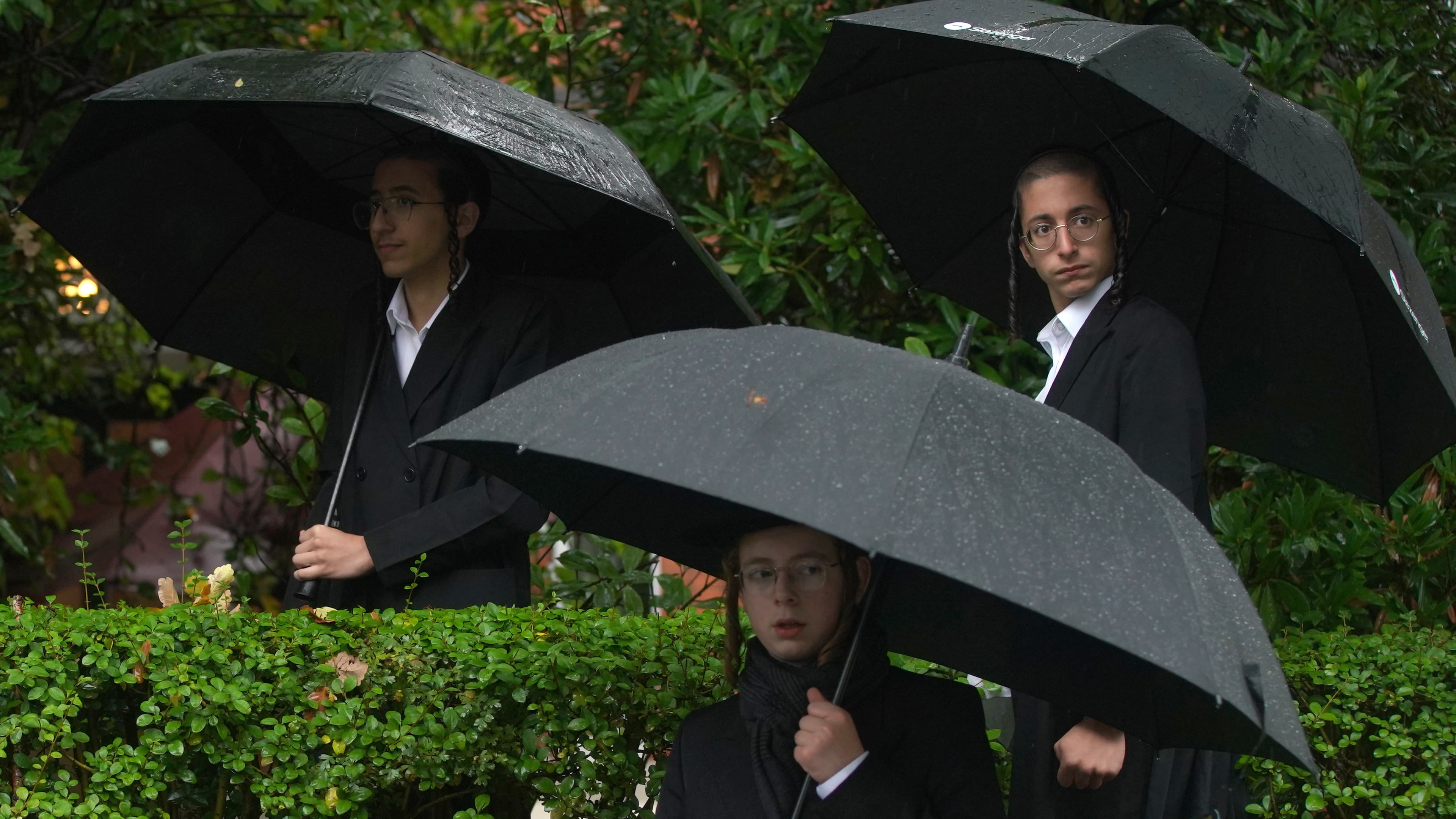 Young Jewish men attend a vigil for the victims of the attack on at Heaton Park Hebrew Congregation synagogue, in Crumpsall, Manchester, England, Friday, Oct. 3, 2025. (AP Photo/Ian Hodgson)