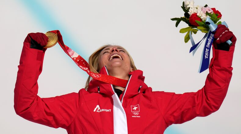 FILE - Lara Gut-Behrami, of Switzerland celebrates during the medal ceremony after winning the gold medal in the women's super-G at the 2022 Winter Olympics, Friday, Feb. 11, 2022, in the Yanqing district of Beijing. (AP Photo/Luca Bruno, File)