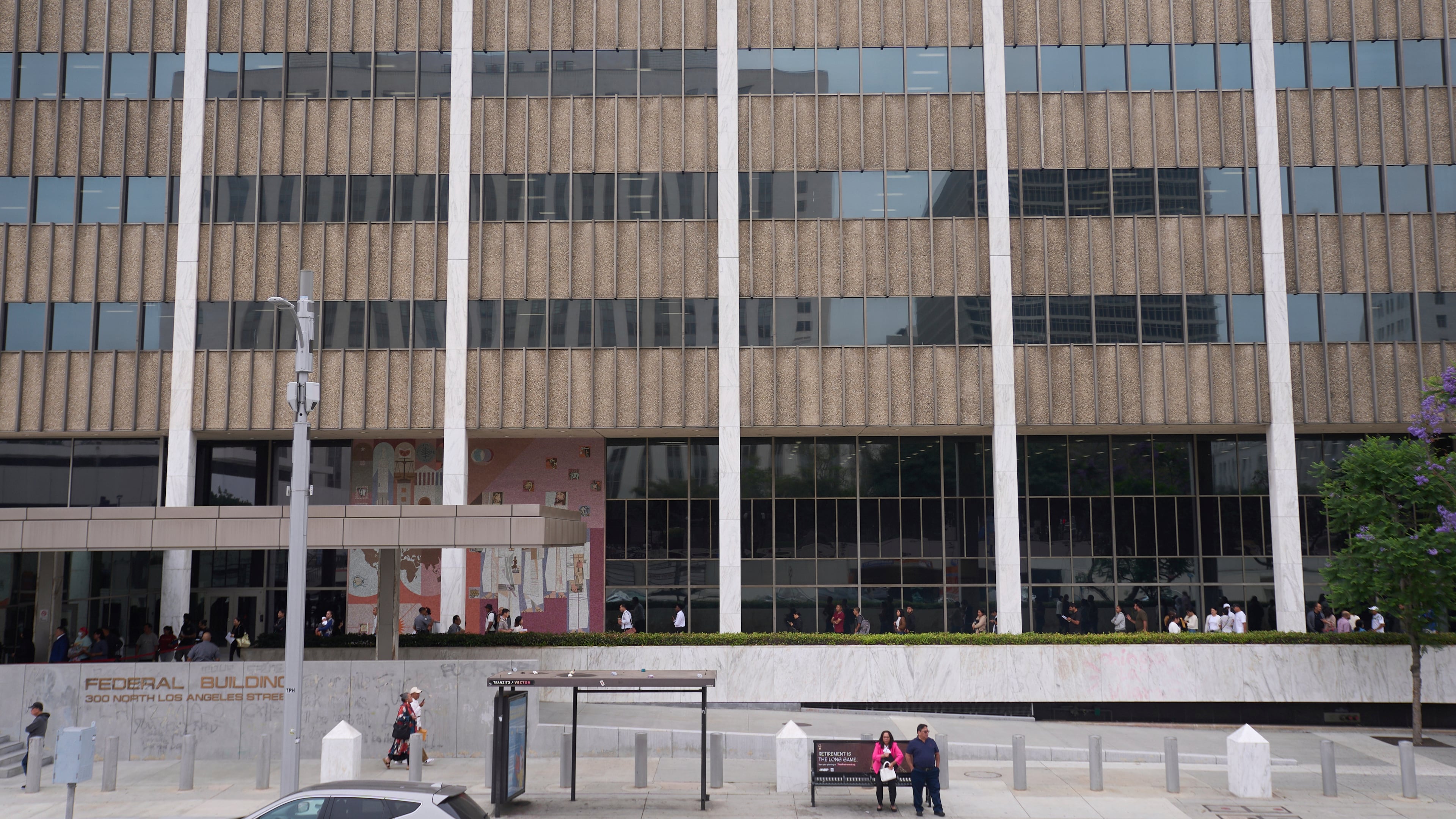 FILE People line up outside the Los Angeles Federal Building in Los Angeles, June 25, 2025. (AP Photo/Damian Dovarganes, File)