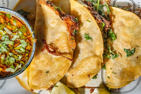 Quesabirria tacos at CT Cantina are served with the traditional side of consommé for dipping. (Courtesy of CT Cantina & Taqueria)