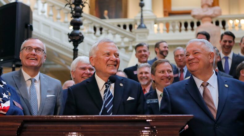 Gov. Nathan Deal, flanked by Lt. Gov. Casey Cagle (left) and House Speaker David Ralston, announced Tuesday that a compromise had been reached on a plan for dealing with the massive state windfall created by the federal tax law. The Georgia House approved the plan, House Bill 918, on Thursday. It calls for a reduction in the state income tax rate and an increase in the standard deduction. BOB ANDRES /BANDRES@AJC.COM