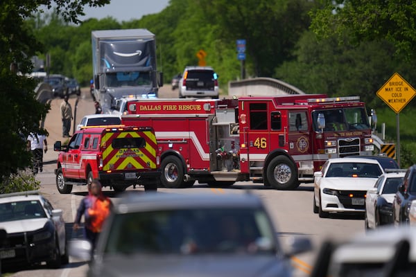 A fire engine blocks a road accessing Wilmer-Hutchins High School, where police are responding to reports of a shooting, in Dallas, Tx., Tuesday, April 15, 2025. (AP Photo/Julio Cortez)