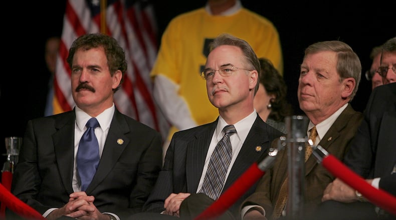 Georgia U.S. Rep. Tom Price, center, and U.S. Sen. Johnny Isakson, right, listen to then-Vice President Dick Cheney during a visit to Smyrna in 2005. (JOHN SPINK/AJC staff)