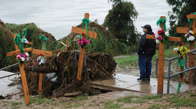 FILE - Rain falls as Irene Valdez visits a make-shift memorial for flood victims along the Guadalupe River, Sunday, July 13, 2025, in Kerrville, Texas. (AP Photo/Eric Gay, File)