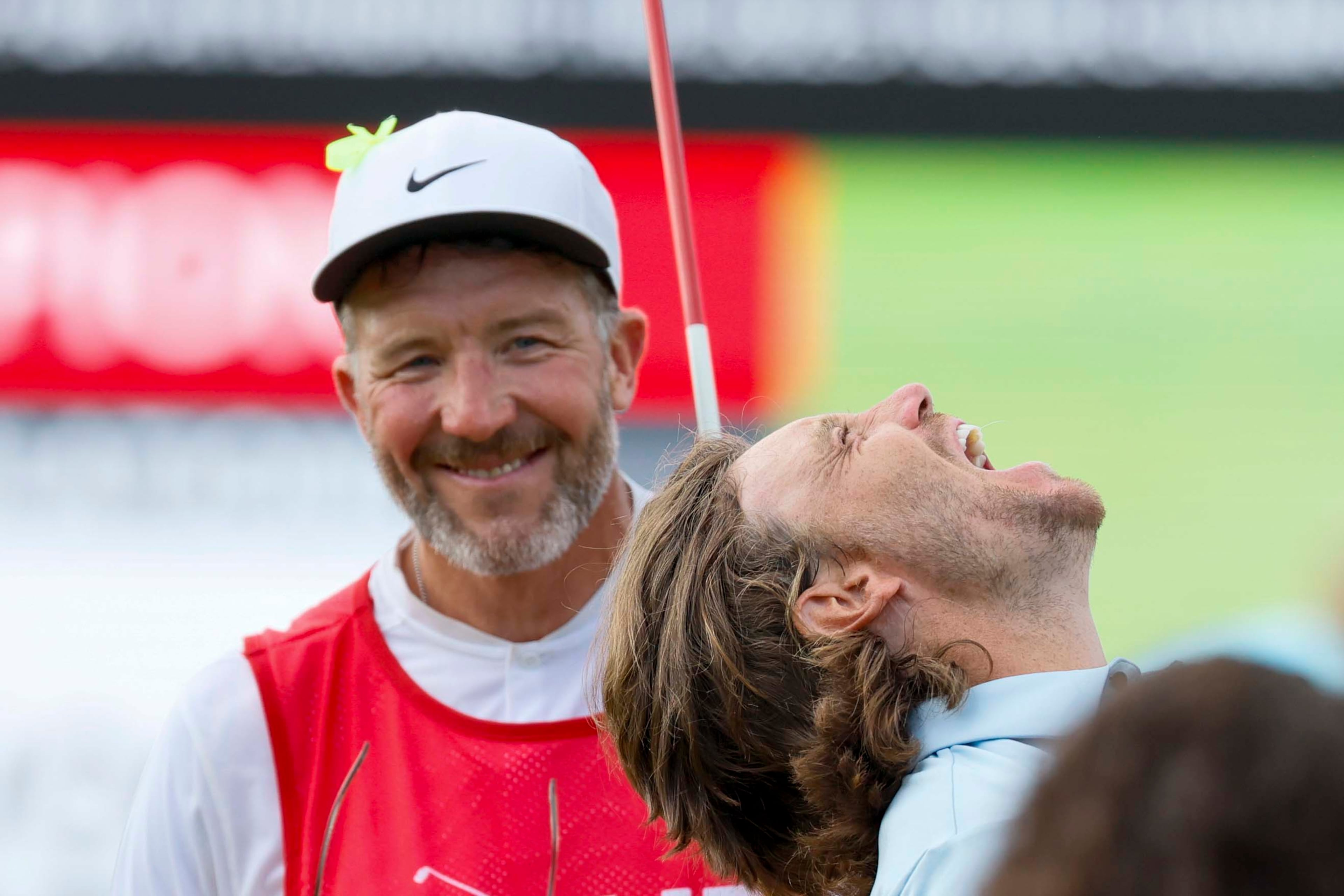 Tommy Fleetwood reacts as his caddie Ian Finnis watches him celebrating after winning the PGA Tour Championship at East Lake Golf Club on Sunday, Aug. 24, 2025, in Atlanta. (Miguel Martinez/ AJC)