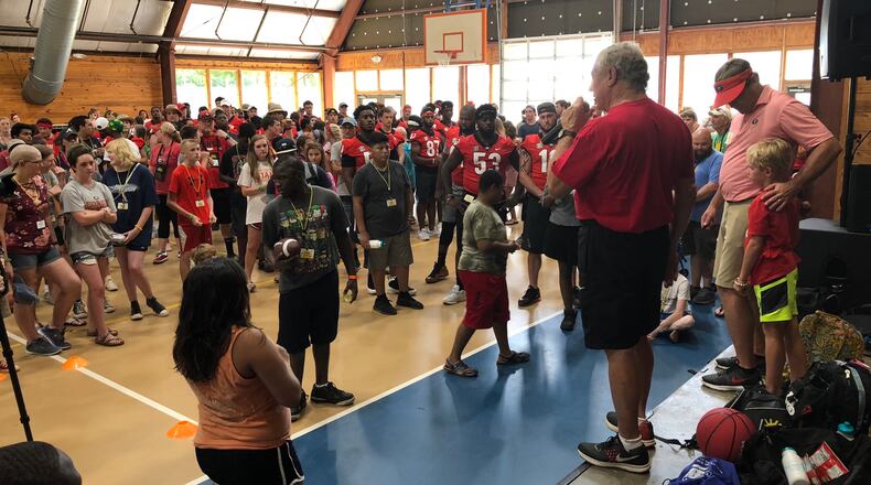 Camp Sunshine commander-in-chief Mo Thrash (with mic) introduces Georgia coach Kirby Smart (R) to campers and Georgia players during the Bulldogs' visit to the Camp Twin Lakes facility for critically-ill children in 2018. (Chip Towers/Chip.Towers@coxinccom)