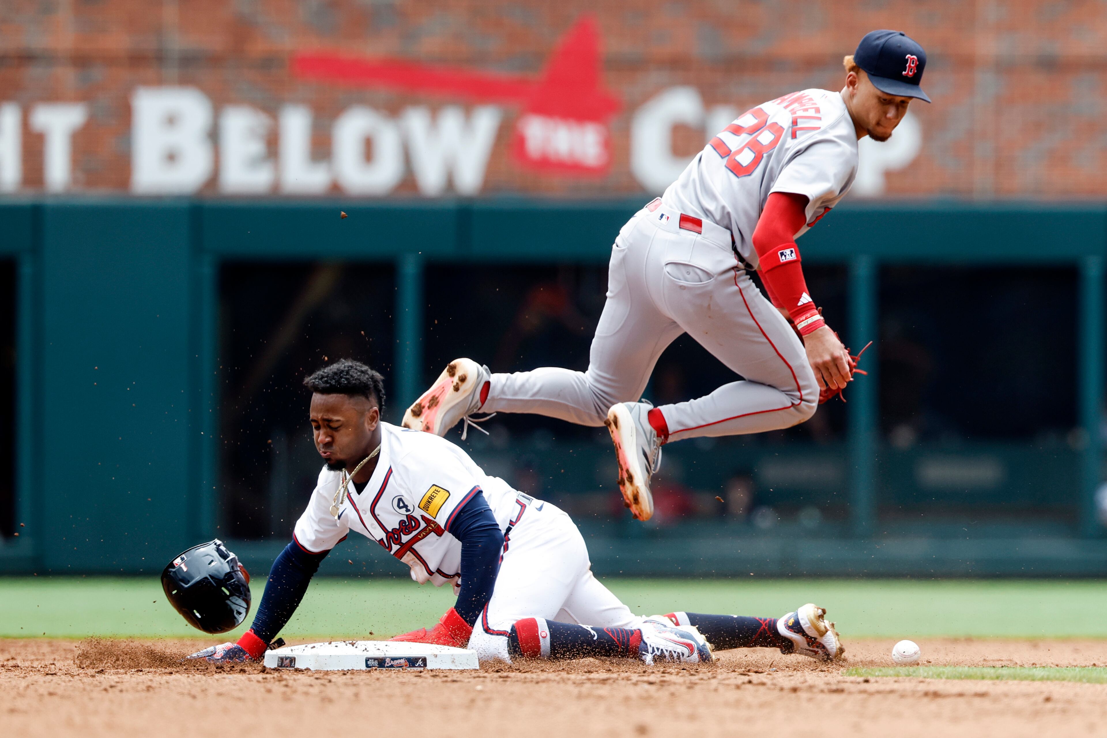 Atlanta Braves' Ozzie Albies (1) is hit by the throw to Boston Red Sox second baseman Kristian Campbell (28) as he safely steals second base during the fourth inning of a baseball game, Sunday, June 1, 2025, in Atlanta. (AP Photo/Butch Dill)