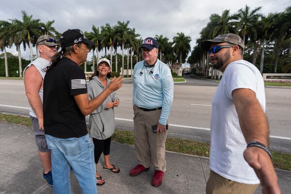Alan Mentser, second from right, from West Palm Beach, Fla., joins other supporters of President Donald Trump outside the Trump International Golf Club, Saturday, March 29, 2025, in West Palm Beach, Fla. (AP Photo/Manuel Balce Ceneta)