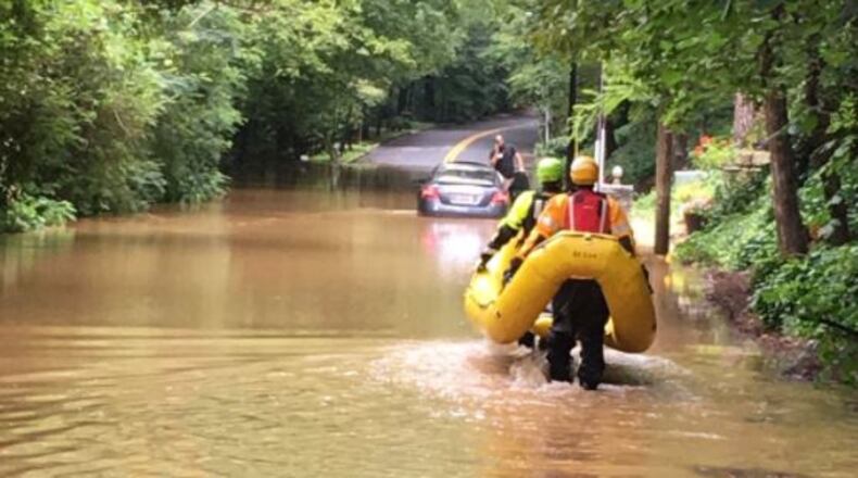Atlanta fire officials rescued a man from the top of his car during flooding Wednesday. (Credit: Atlanta Fire Rescue)
