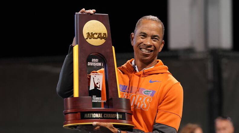 Florida men's tennis coach Bryan Shelton poses with the NCAA championship trophy after leading the Gators to a 4-1 win over Baylor in the title match May 22, 2021 in Orlando, Fla. Shelton, a Georgia Tech grad, became the first coach to lead men's and women's tennis teams to NCAA national championships.
(Manuela Davies/USTA)
