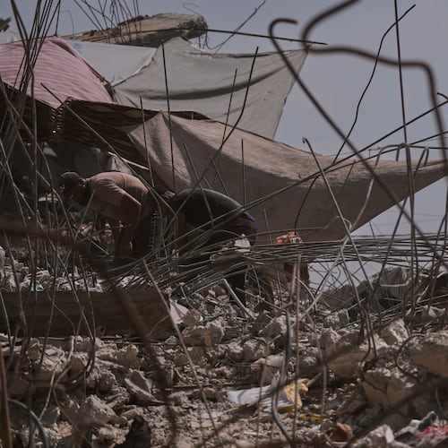 Palestinians remove iron from the rubble of buildings destroyed by Israeli airstrikes during the war with Hamas, repair and recycle it for construction, building tents or selling it, in Gaza City, Sunday, Aug. 16, 2026. (AP Photo/Jehad Alshrafi)