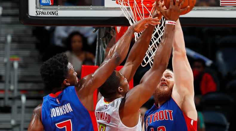 Stanley Johnson (7) and Aron Baynes (12) of the Pistons attempt to break up a pass to Dwight Howard (8) of the Hawks at Philips Arena on October 13, 2016 in Atlanta, Georgia. (Photo by Kevin C. Cox/Getty Images)