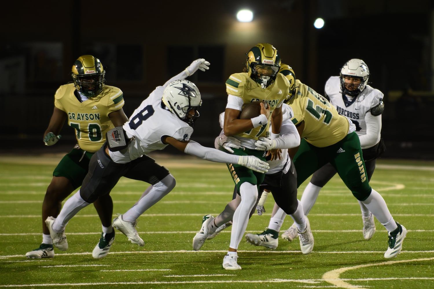 Grayson quarterback Travis Burgess, #17, is tackled. (Jamie Spaar for the Atlanta Journal Constitution)