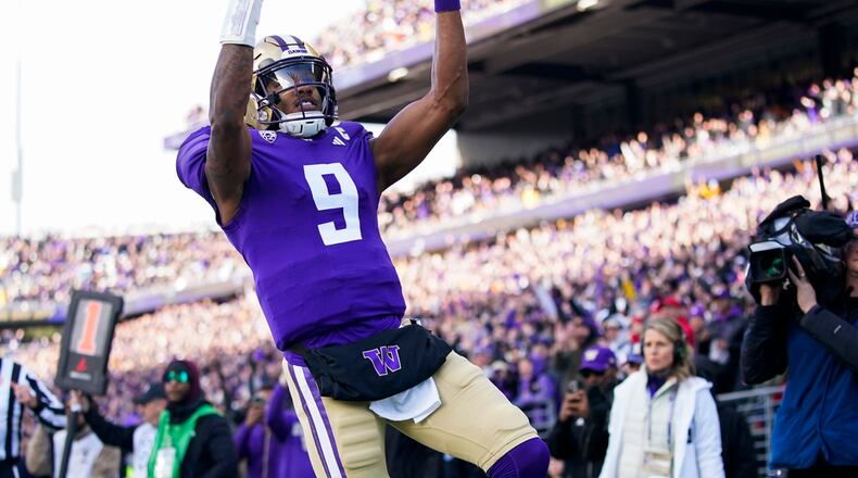 Washington quarterback Michael Penix Jr. reacts after scoring a touchdown against Utah during the first half of an NCAA college football game Saturday, Nov. 11, 2023, in Seattle. (AP Photo/Lindsey Wasson)