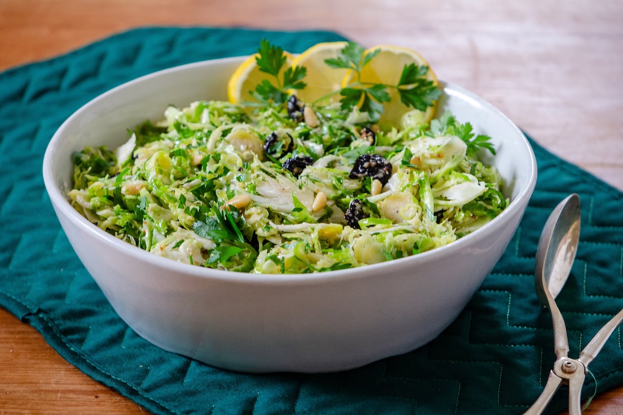 Crispy raw, shaved Brussels sprouts, tossed in whole lemon dressing with dried cherries and herbs, make a delicious hearty slaw. (Courtesy of Virginia Willis)