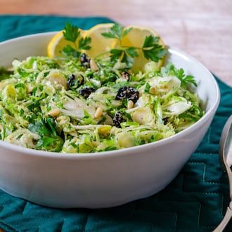 Crispy raw, shaved Brussels sprouts, tossed in whole lemon dressing with dried cherries and herbs, make a delicious hearty slaw. (Courtesy of Virginia Willis)