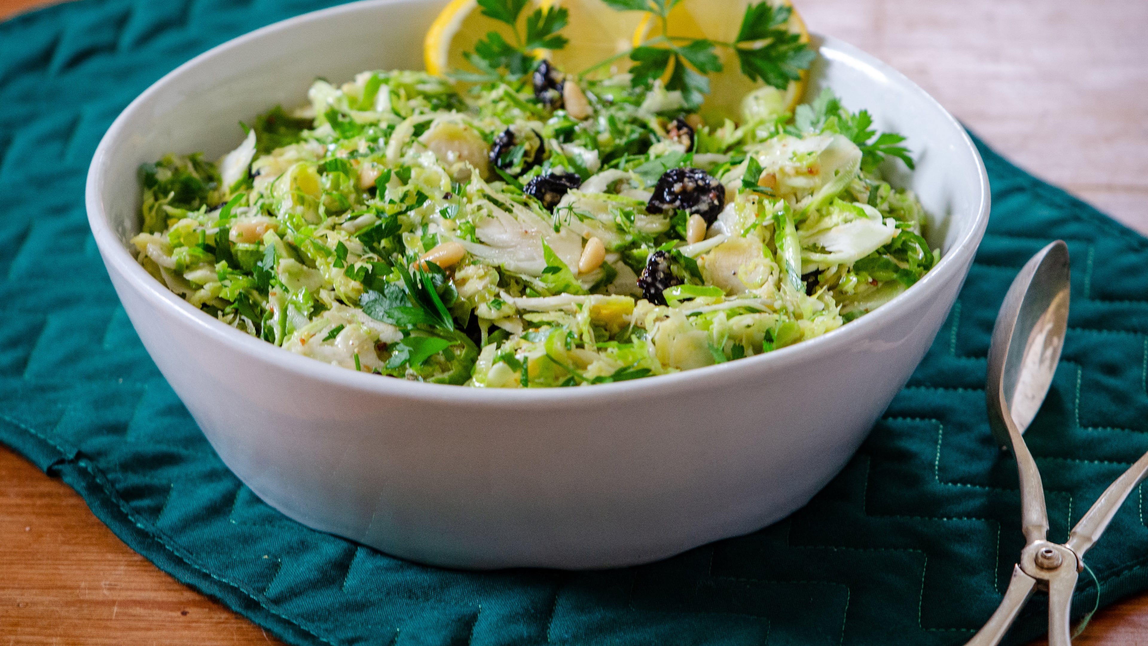 Crispy raw, shaved Brussels sprouts, tossed in whole lemon dressing with dried cherries and herbs, make a delicious hearty slaw. (Courtesy of Virginia Willis)