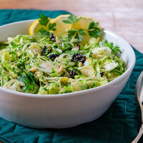 Crispy raw, shaved Brussels sprouts, tossed in whole lemon dressing with dried cherries and herbs, make a delicious hearty slaw. (Courtesy of Virginia Willis)